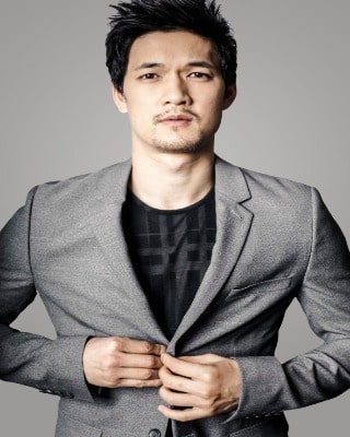 Harry Shum Jr wearing silvery white coat